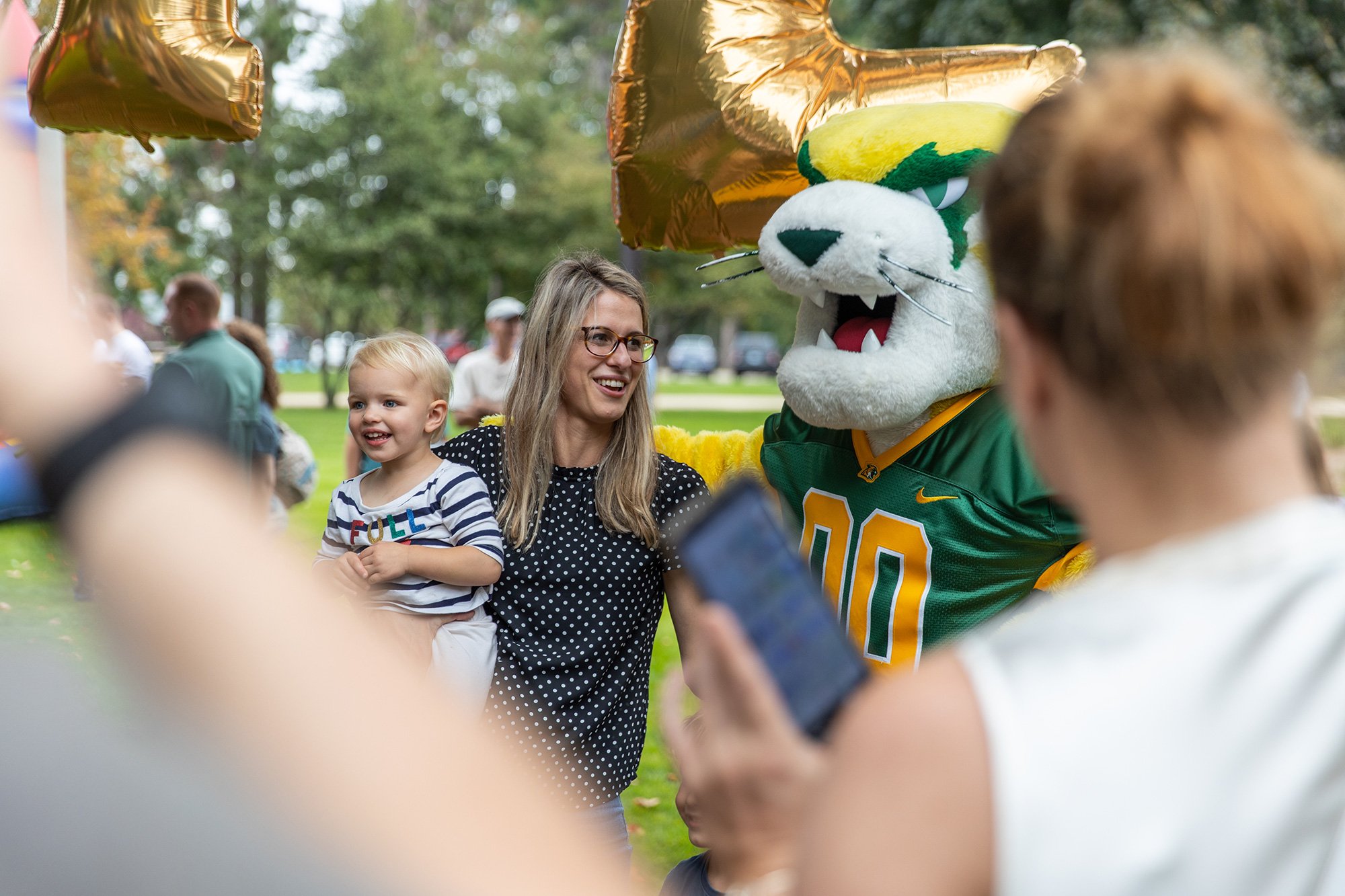 Mother and child with Wildcat Willy at a community event